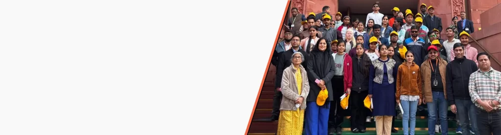 HTBF staff, volunteers, and visually impaired students from Delhi stand together for a group photo during an exposure visit.