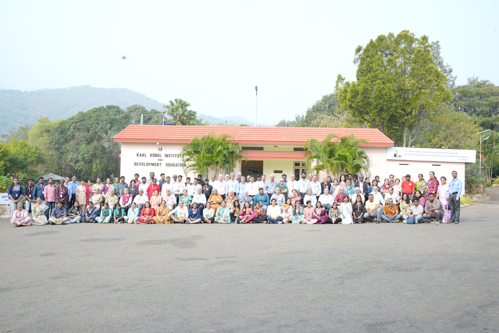 A large group photo of HTBF Team members in front of the Karl Kubel Institute for Development Education building taken during the annual meet.